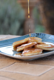 Baby Puffs Drenched with Butterscotch Scotch, Served with Raspberries and Toasted Almonds.